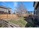 Fenced backyard with a small deck and mature tree at 8653 Red Clover Ct, Parker, CO 80134