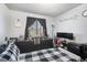 Cozy bedroom with a black and white theme, large window, and ample storage space at 8653 Red Clover Ct, Parker, CO 80134