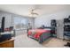 Well-lit bedroom with ceiling fan, window and neutral carpet and walls at 8653 Red Clover Ct, Parker, CO 80134