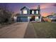 Charming two-story home with a blue exterior, well-manicured lawn, and a cozy front porch at 8653 Red Clover Ct, Parker, CO 80134