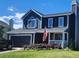 Charming two-story home with a blue exterior, well-manicured lawn, and a cozy front porch at 8653 Red Clover Ct, Parker, CO 80134