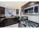 Updated kitchen features stainless steel appliances including a gas range and microwave, plus dark wood cabinets at 8653 Red Clover Ct, Parker, CO 80134