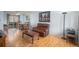 Inviting living room featuring hardwood floors, a comfortable leather sofa, and sliding door to the backyard at 8653 Red Clover Ct, Parker, CO 80134