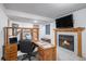 Home office with wooden desk, fireplace, and natural light at 8653 Red Clover Ct, Parker, CO 80134