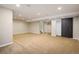 Spacious finished basement with recessed lighting and carpet flooring, a sliding barn door at 14000 Winding River Ct # T3, Broomfield, CO 80023