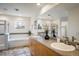 Luxurious primary bathroom with double sinks, a large mirror, soaking tub, and walk-in shower at 14000 Winding River Ct # T3, Broomfield, CO 80023