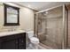 Beautiful bathroom features a glass-enclosed shower, dark wood vanity, and neutral tile at 14000 Winding River Ct # T3, Broomfield, CO 80023