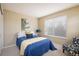 Bright bedroom features a large window, neutral walls, and cozy carpet at 14000 Winding River Ct # T3, Broomfield, CO 80023