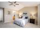 Serene primary bedroom with natural light, ceiling fan, and a glimpse into the ensuite bathroom at 14000 Winding River Ct # T3, Broomfield, CO 80023