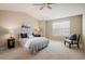 Relaxing bedroom with a vaulted ceiling, neutral tones, ceiling fan, and a comfortable seating area at 14000 Winding River Ct # T3, Broomfield, CO 80023