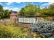 Welcoming community sign with stone accents and lush landscaping at 14000 Winding River Ct # T3, Broomfield, CO 80023