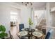 Contemporary dining area with a table set for four and a view leading into the modern home at 14000 Winding River Ct # T3, Broomfield, CO 80023