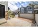 Charming townhome exterior featuring gray siding, stone accents, and a patio at 14000 Winding River Ct # T3, Broomfield, CO 80023