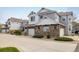 Beautiful townhome featuring stone accents, attached garage, and well-maintained landscaping at 14000 Winding River Ct # T3, Broomfield, CO 80023