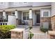 Charming townhome featuring a covered front porch with stone accents and a cozy seating area at 14000 Winding River Ct # T3, Broomfield, CO 80023