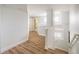 Bright hallway with wood floors, white walls, and modern staircase leading into the house at 14000 Winding River Ct # T3, Broomfield, CO 80023