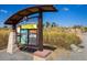 Community nature play area and bike park information kiosk with maps and details at 14000 Winding River Ct # T3, Broomfield, CO 80023