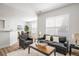 Open-concept living room with modern furniture, neutral walls, and abundant natural light at 14000 Winding River Ct # T3, Broomfield, CO 80023