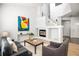 Bright living room with a fireplace, neutral walls, and contemporary decor at 14000 Winding River Ct # T3, Broomfield, CO 80023