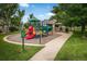 Community playground area with colorful play structure and seating area for families at 14000 Winding River Ct # T3, Broomfield, CO 80023