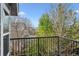 View from the metal railing balcony of the surrounding neighborhood with mature trees at 9714 Chanteclair Cir, Highlands Ranch, CO 80126