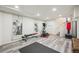 Spacious basement featuring modern gym equipment and stylish laminate flooring and serene oriental artwork on the walls at 9714 Chanteclair Cir, Highlands Ranch, CO 80126