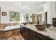 Bathroom featuring double sinks, granite countertops, soaking tub, and walk-in shower at 9714 Chanteclair Cir, Highlands Ranch, CO 80126