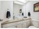 Modern bathroom with a vessel sink, granite countertop, and skylight for natural light at 9714 Chanteclair Cir, Highlands Ranch, CO 80126