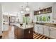 Bright kitchen with an island, granite countertops, and modern appliances, flowing into an open dining area at 9714 Chanteclair Cir, Highlands Ranch, CO 80126