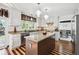 Open-concept kitchen with an island, modern appliances, and beautiful wood floors, ideal for entertaining at 9714 Chanteclair Cir, Highlands Ranch, CO 80126