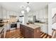 Spacious kitchen featuring a center island, stainless steel appliances, and stylish pendant lighting at 9714 Chanteclair Cir, Highlands Ranch, CO 80126