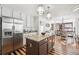 Open-concept kitchen featuring an island, granite countertops, stainless steel appliances, and a view of the adjacent dining area at 9714 Chanteclair Cir, Highlands Ranch, CO 80126