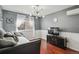 Cozy living area with wood floors, modern lighting, and large window at 9714 Chanteclair Cir, Highlands Ranch, CO 80126