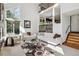Bright and airy living room with a large window, comfortable seating, and an open staircase at 9714 Chanteclair Cir, Highlands Ranch, CO 80126