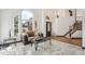 Bright living room with large arched windows, tile floors, and a modern coffee table, creating an inviting atmosphere at 9714 Chanteclair Cir, Highlands Ranch, CO 80126