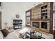 Cozy living room featuring a stone fireplace, built-in shelves, and comfortable seating arrangement at 9714 Chanteclair Cir, Highlands Ranch, CO 80126