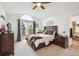 Bright main bedroom with balcony access, vaulted ceiling, and ensuite bathroom at 9714 Chanteclair Cir, Highlands Ranch, CO 80126