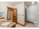 Well-lit bathroom with double sinks, granite countertop, wooden door and tiled shower at 378 Juniata Cir, Breckenridge, CO 80424