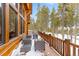 Exterior wooden deck with outdoor furniture and views of tall evergreen trees at 378 Juniata Cir, Breckenridge, CO 80424