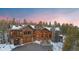 Charming log home with stone accents, a well-manicured driveway, and inviting front entrance at 378 Juniata Cir, Breckenridge, CO 80424