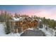 Stunning log home with a stone foundation and snowy landscaping at 378 Juniata Cir, Breckenridge, CO 80424