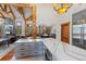 An open kitchen with island seating flows to a cozy living room with a fireplace at 378 Juniata Cir, Breckenridge, CO 80424