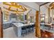 Open-concept kitchen with an island, wood beam accents, and views into the dining area at 378 Juniata Cir, Breckenridge, CO 80424