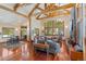 Bright living room showcases exposed beams, hardwood floors, and scenic views from expansive windows, creating a warm ambiance at 378 Juniata Cir, Breckenridge, CO 80424