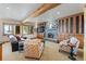 Inviting living room with stone fireplace, wood beam accents, and large windows with scenic views at 378 Juniata Cir, Breckenridge, CO 80424
