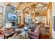 Cozy living room featuring a grand stone fireplace, exposed beams, and comfortable seating arrangements at 378 Juniata Cir, Breckenridge, CO 80424