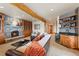 Open-concept living room with a stone fireplace, wet bar, wood beam and comfortable seating at 378 Juniata Cir, Breckenridge, CO 80424