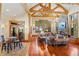 Spacious living room features beautiful wood floors, exposed beams, stone fireplace, and large windows with scenic views at 378 Juniata Cir, Breckenridge, CO 80424