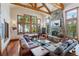 Bright living room featuring large windows, a stone fireplace, and comfortable seating with great views at 378 Juniata Cir, Breckenridge, CO 80424