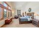Spacious main bedroom with stone fireplace, sitting area, large windows with scenic views, and a king-sized bed at 378 Juniata Cir, Breckenridge, CO 80424